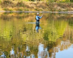 An angler on calm fall water at the Lower Illinois River