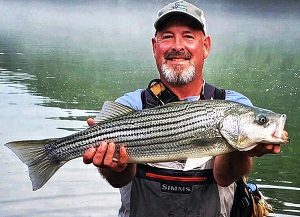 A chapter member with a striped bass