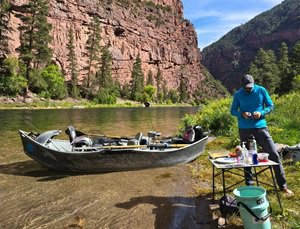 A drift boat on the bank of the Green River in Utah
